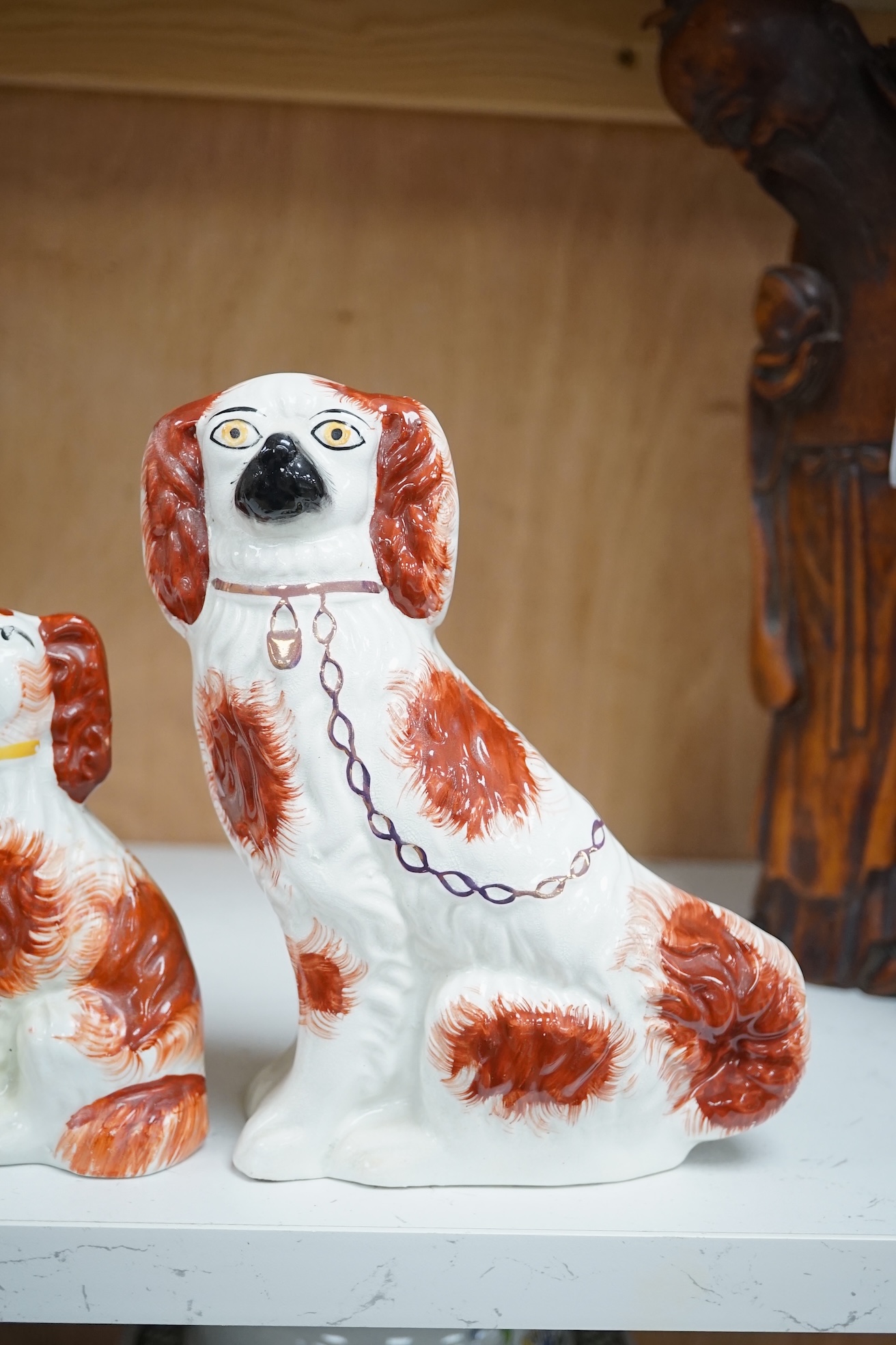 A pair of Staffordshire potter spaniels, and a similar smaller example, taller 18cm. Condition - smaller and one larger heavily restored